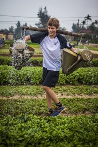 boy carrying bags in Vietnam