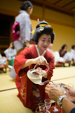 Japanese woman pouring tea into a mug